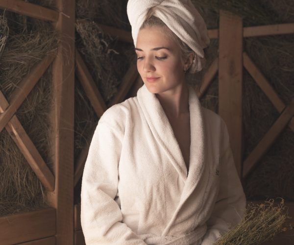 smiling-beautiful-young-woman-sitting-bench-sauna smiling-beautiful-young-woman-sitting-bench-sauna